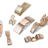 a pile of metal nickel plated and bronze fasteners